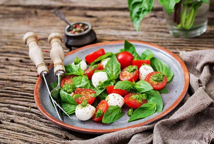 Healthy Salad with cherry tomatoes, mozzarella balls and basil