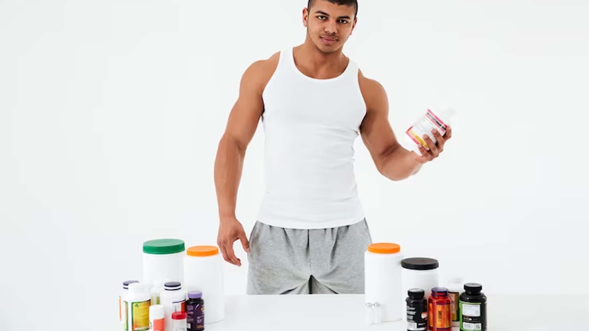 Sports man holding pills