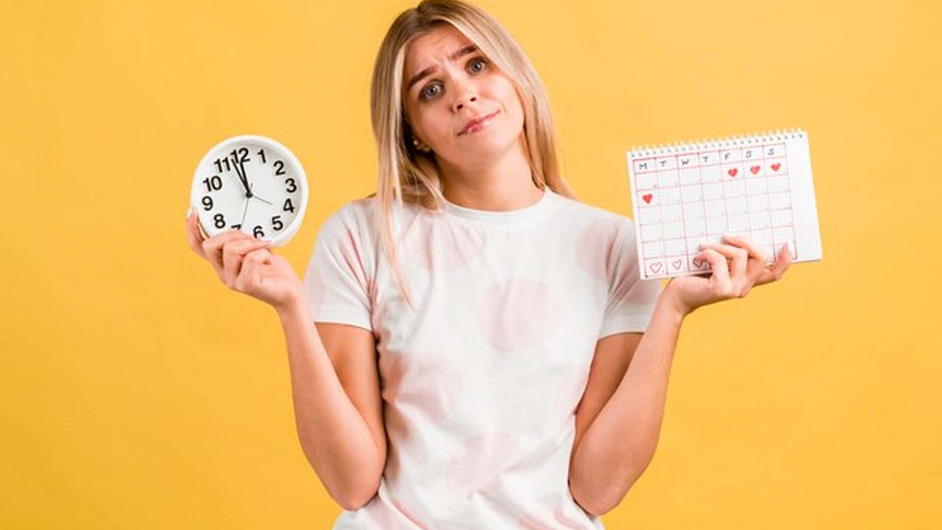 Women Holding Alarm and menstrual calendar