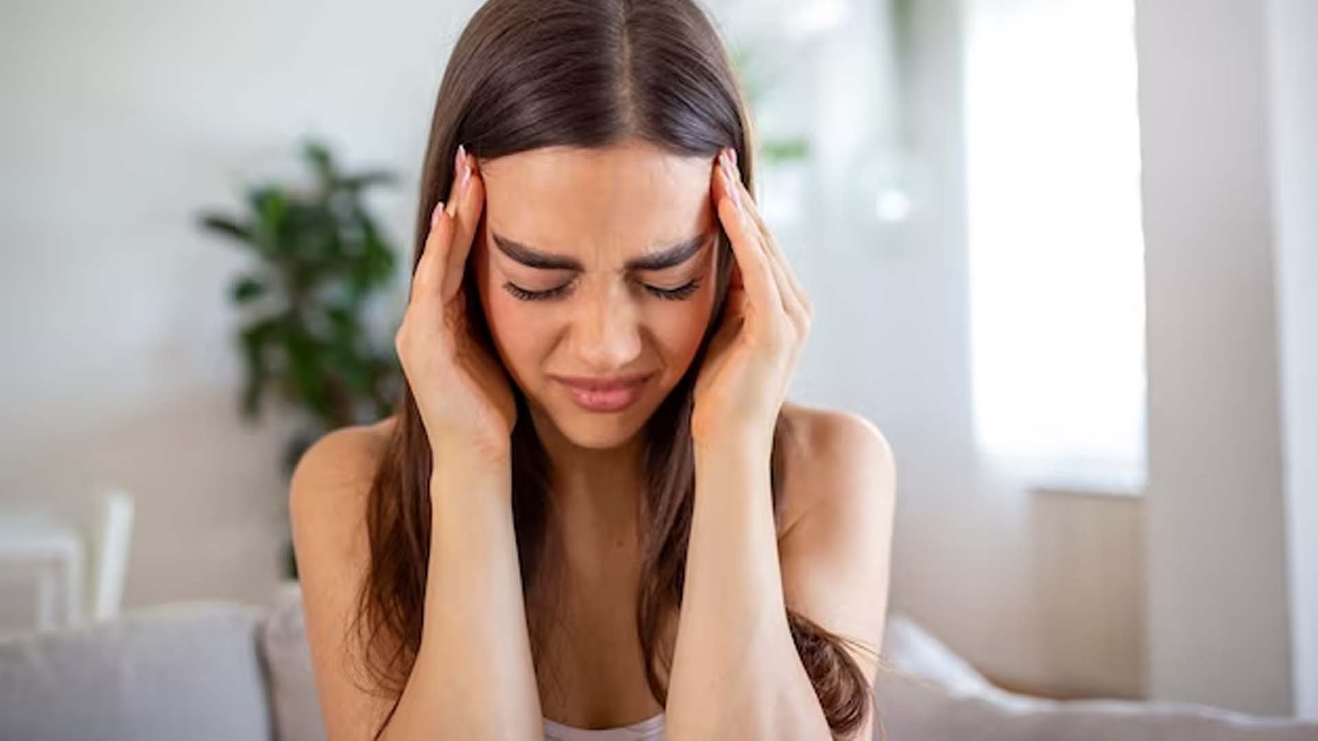Women Holding Head Tight With Headache