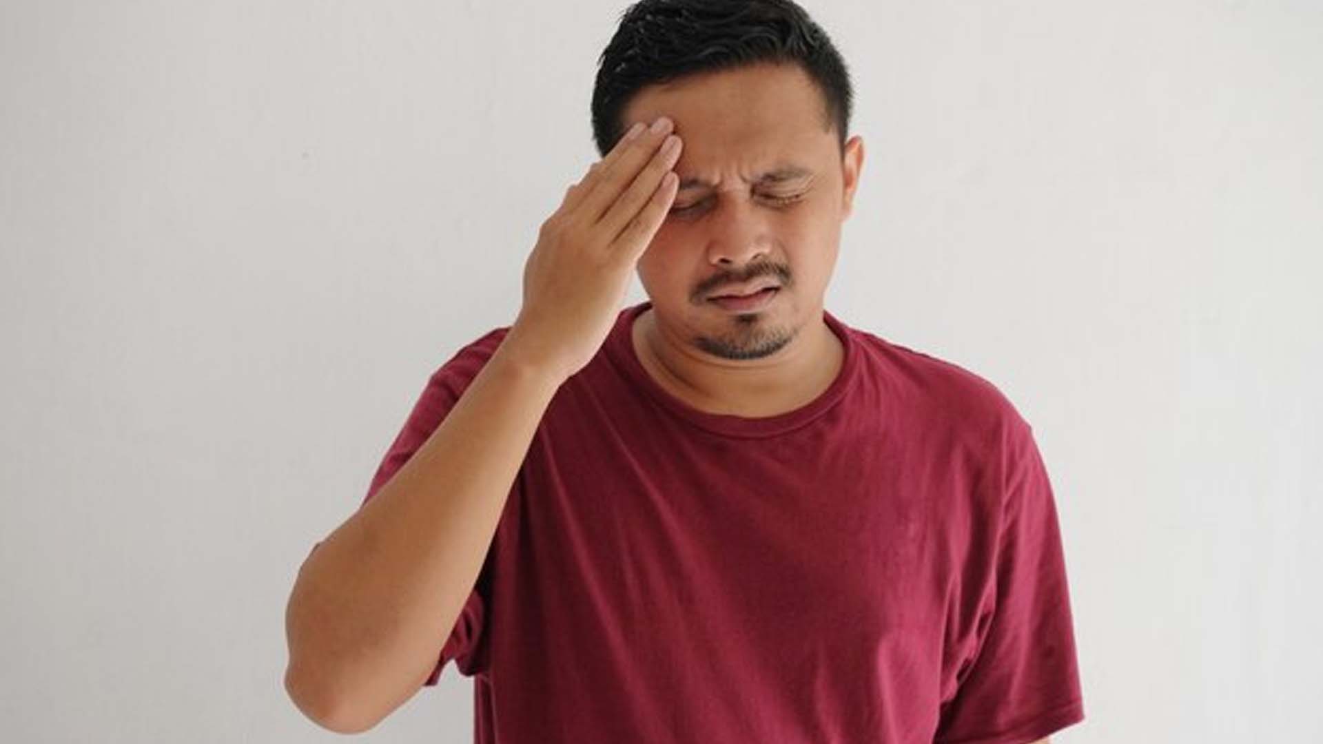 Man Holding his head with Headache