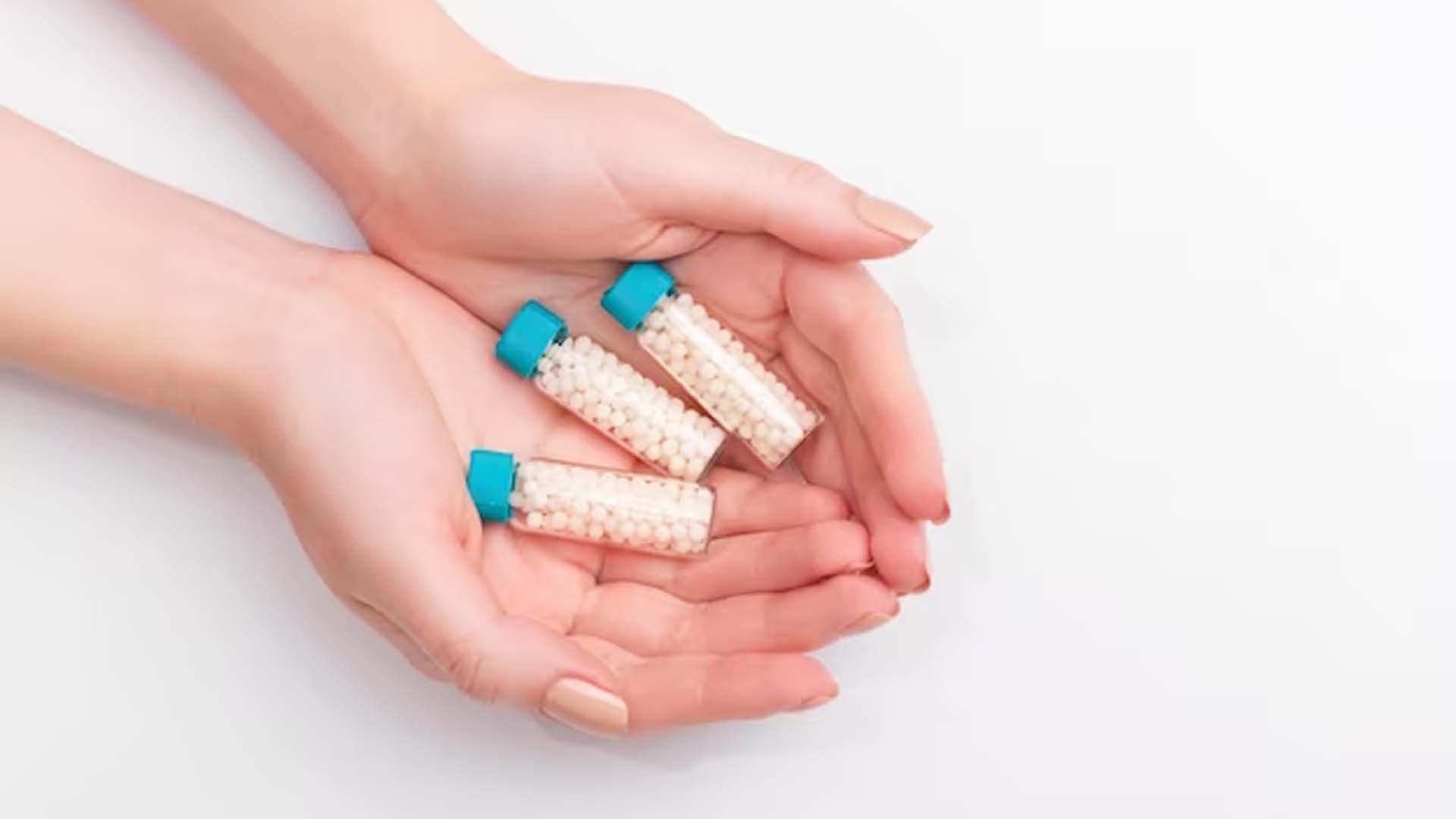 Women Holding Homeopathy Medicines