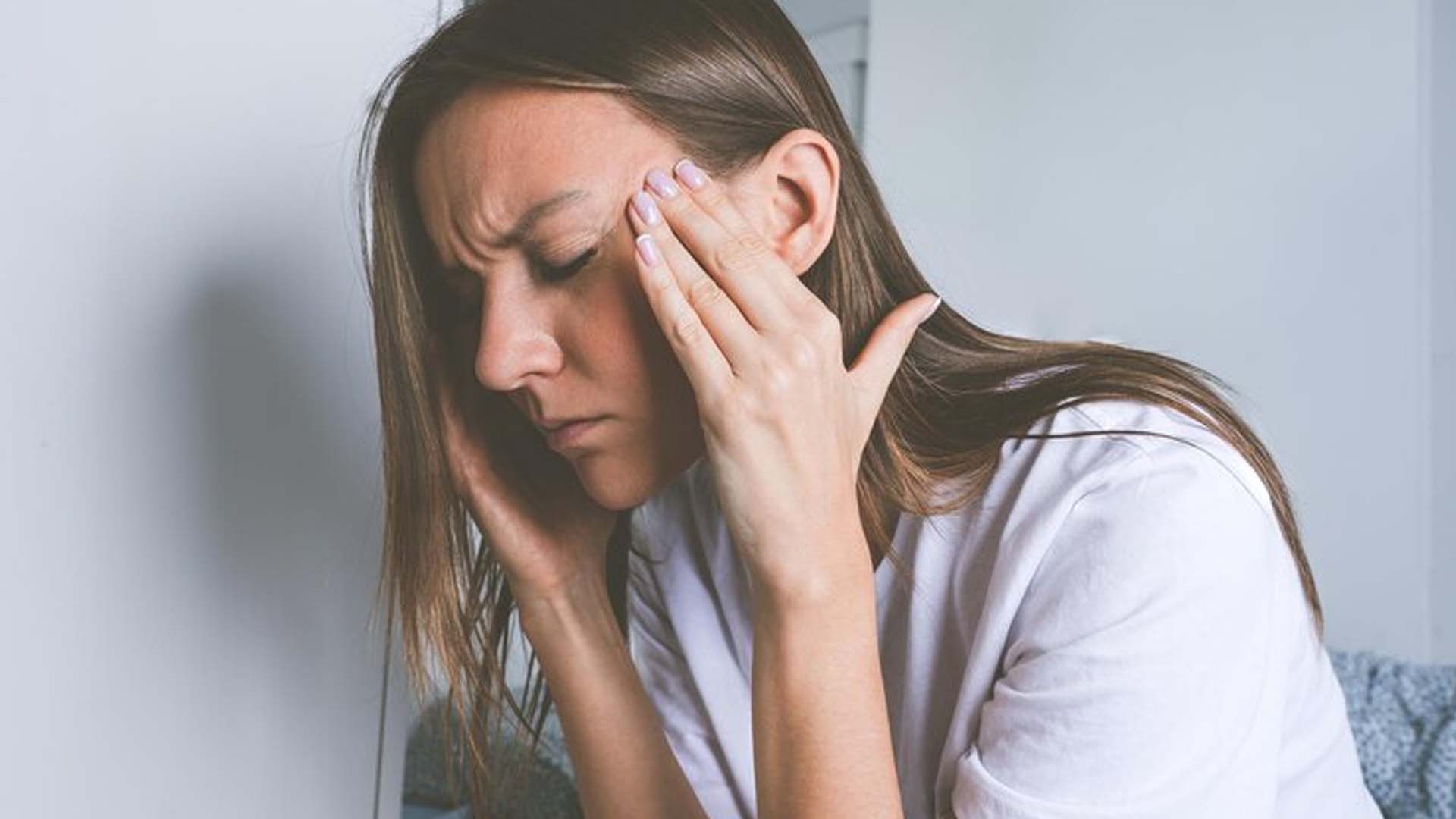 Women Holding head with Tension or Stress Headache