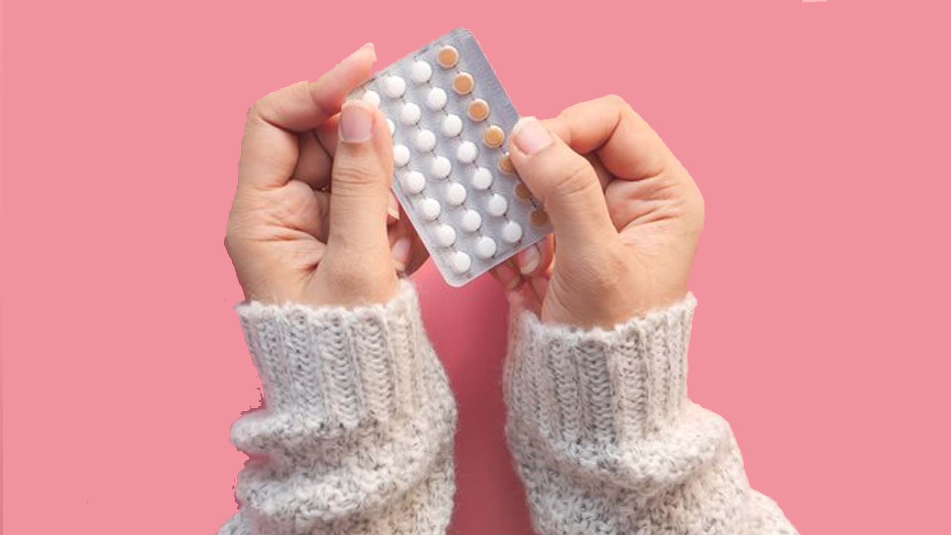 Holding Birth Control Pills (contraceptive pills)
