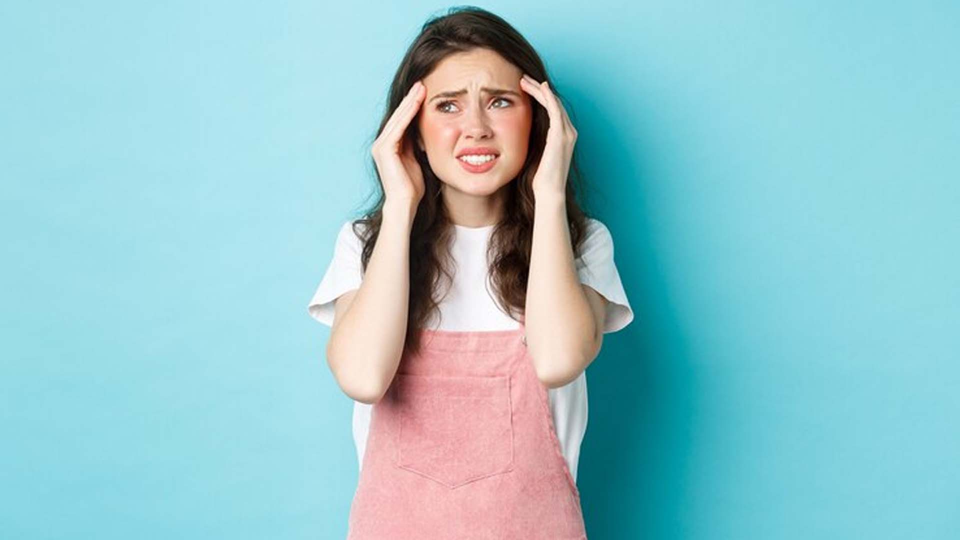 Women with Headache Holding Her head