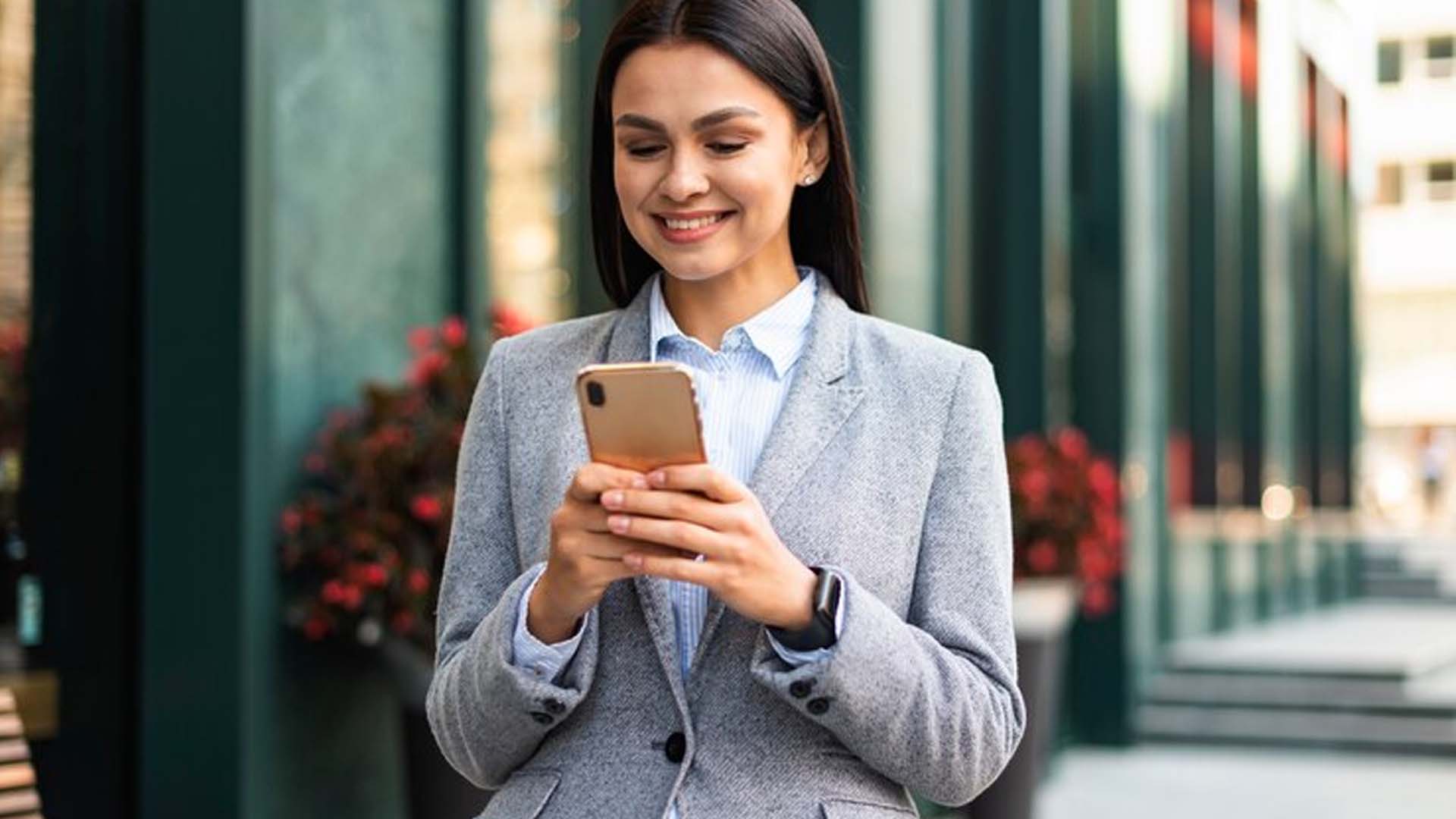 Women using Mobile and smiling