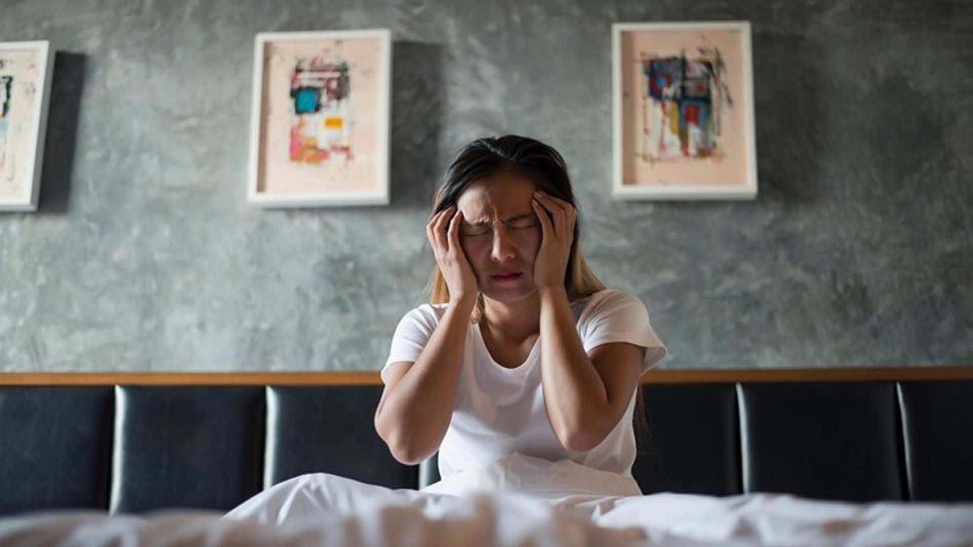 Women on Bed Suffering with Headache