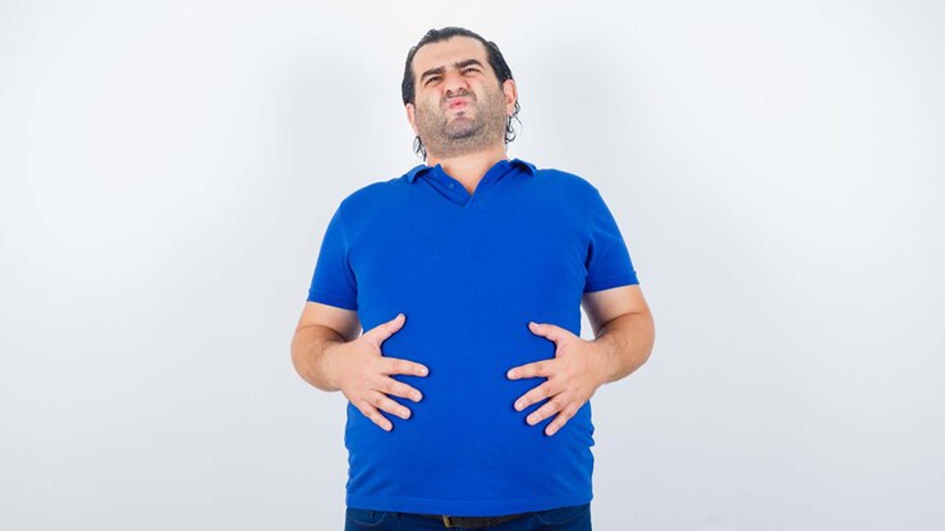 Man Holding Stomach with Gas and Bloating