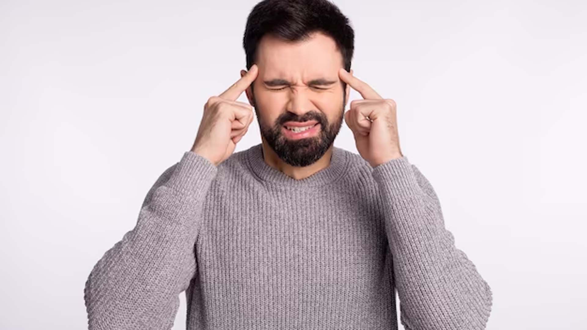 Man Holding Head with Headache