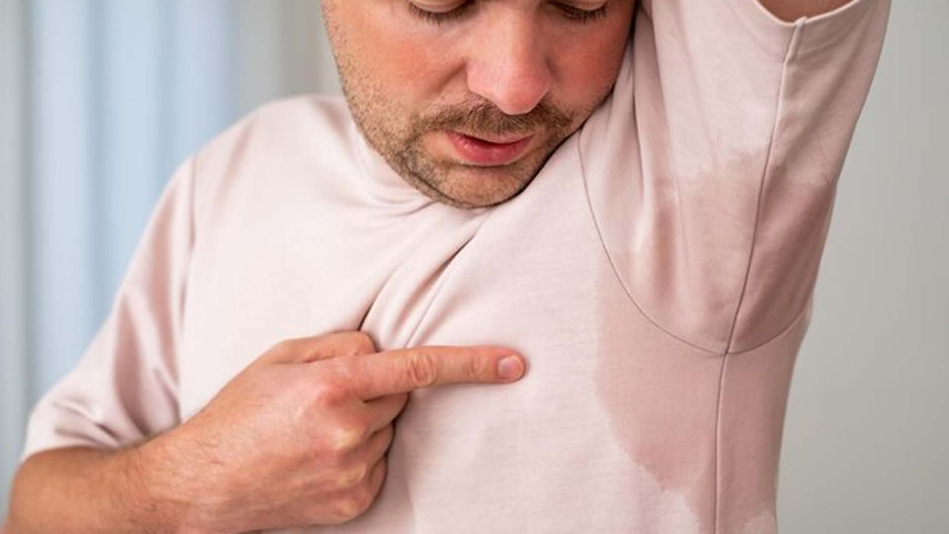 Man Showing Sweat Under Armpits