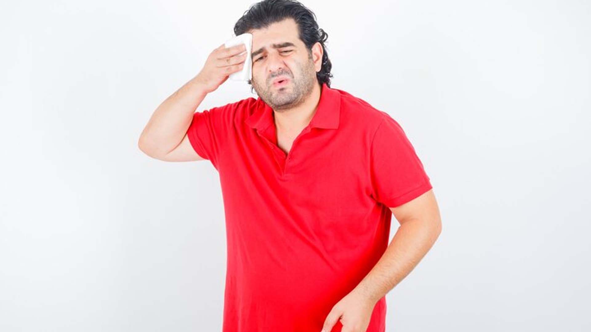 Obese Man Wiping Sweat