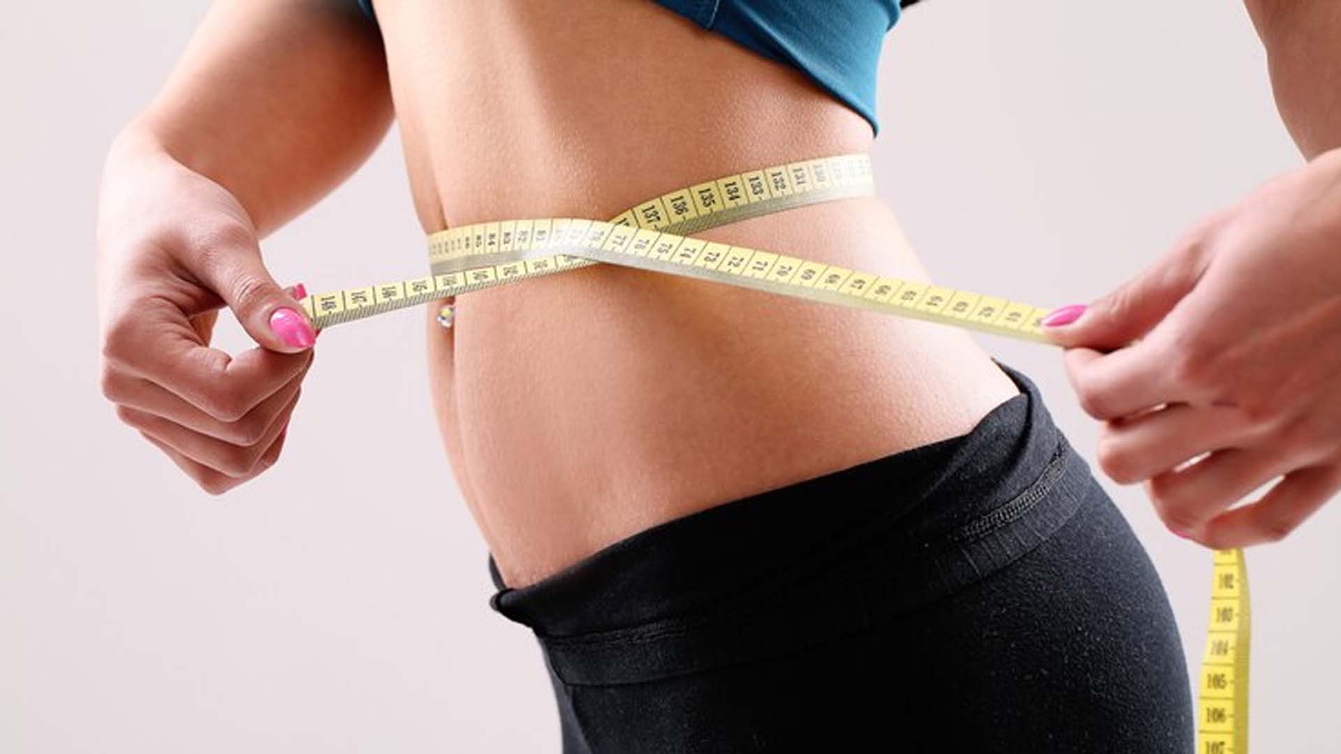 Women Measuring waist with Measuring tape