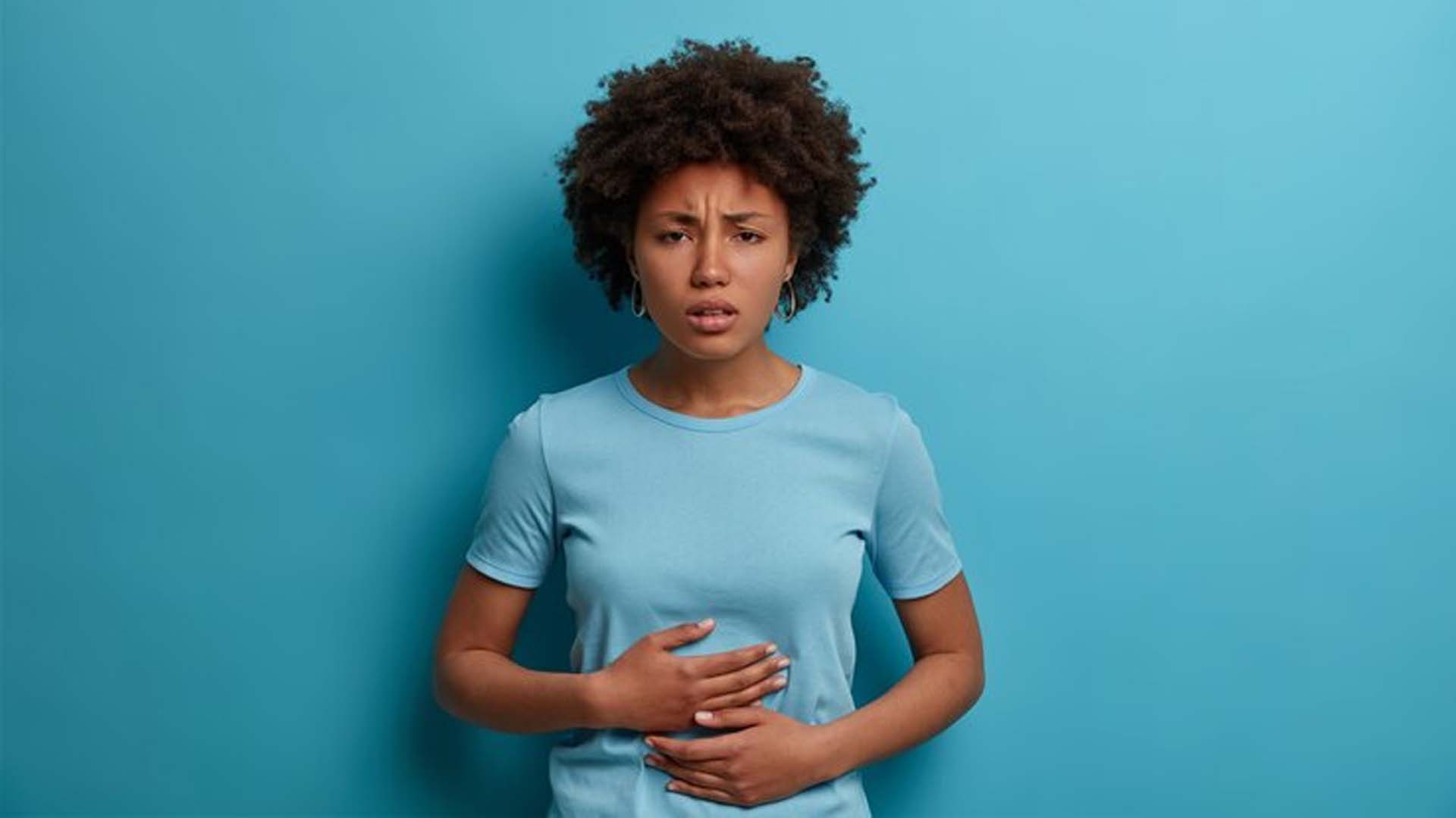 Women Holding Stomach with Bloating