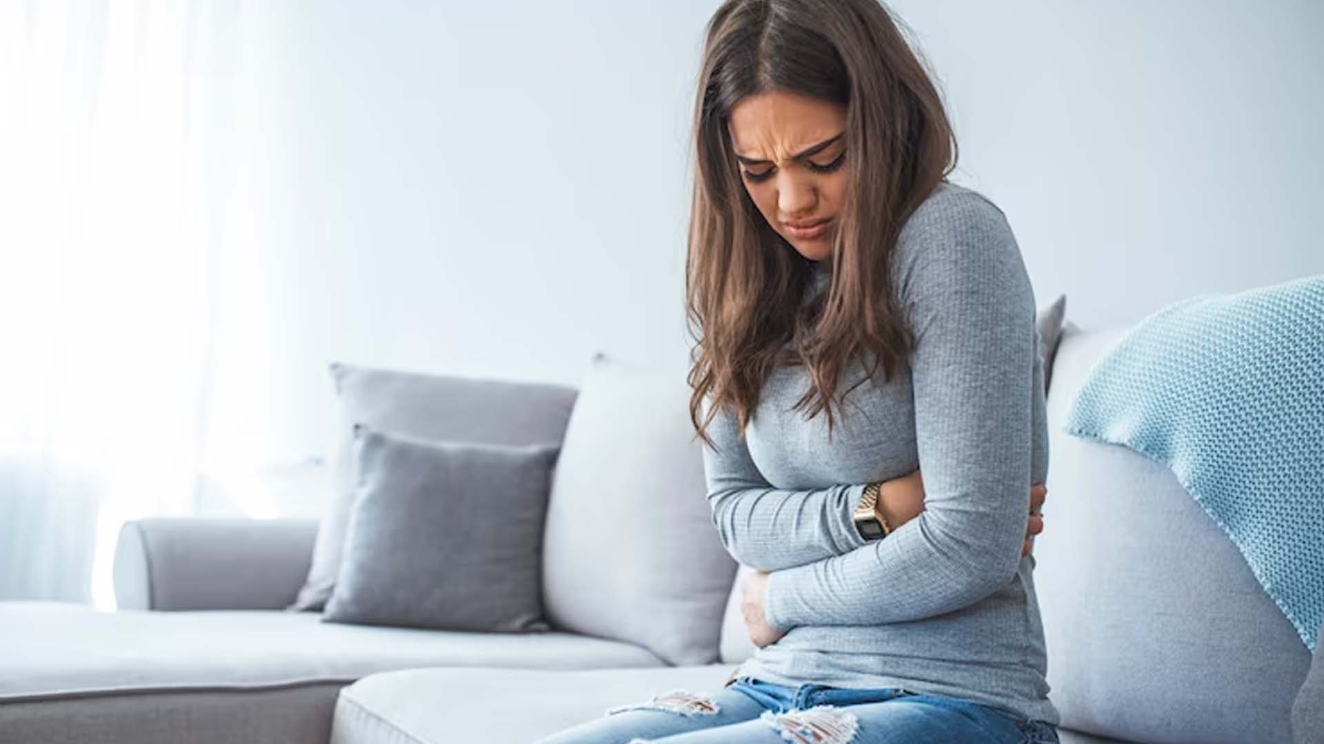 Women Holding Stomach with Pain