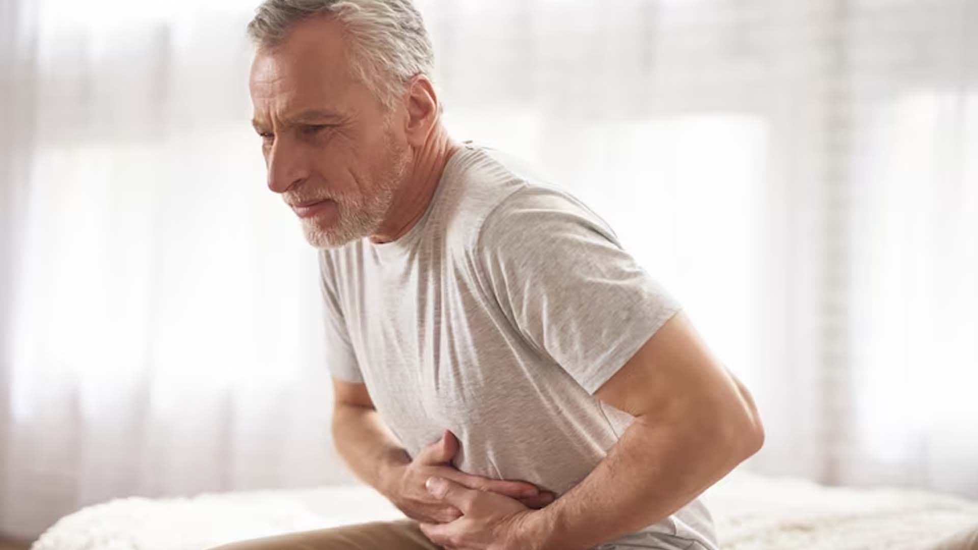 Man holding Stomach with Pain