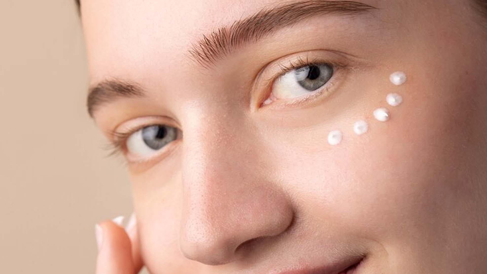 Women applying under Eye Cream