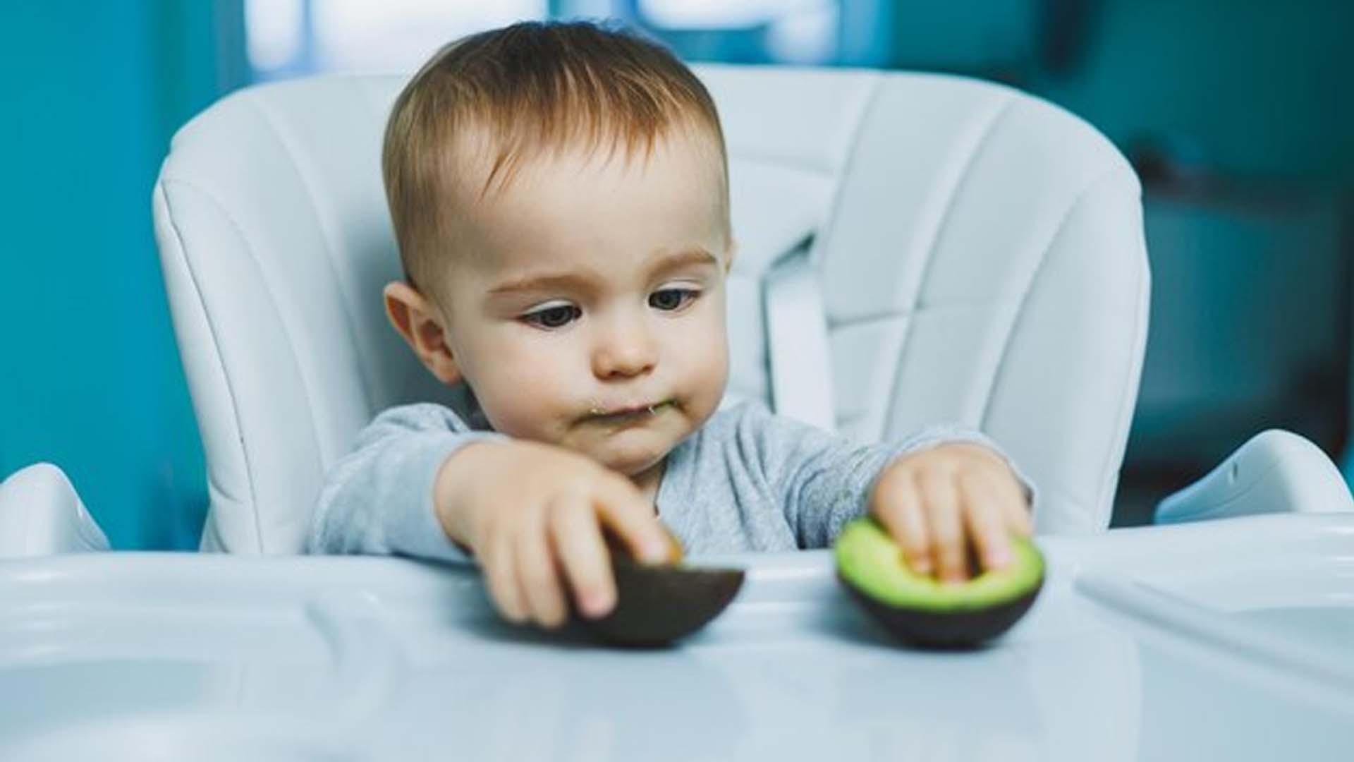Baby eating Avocado