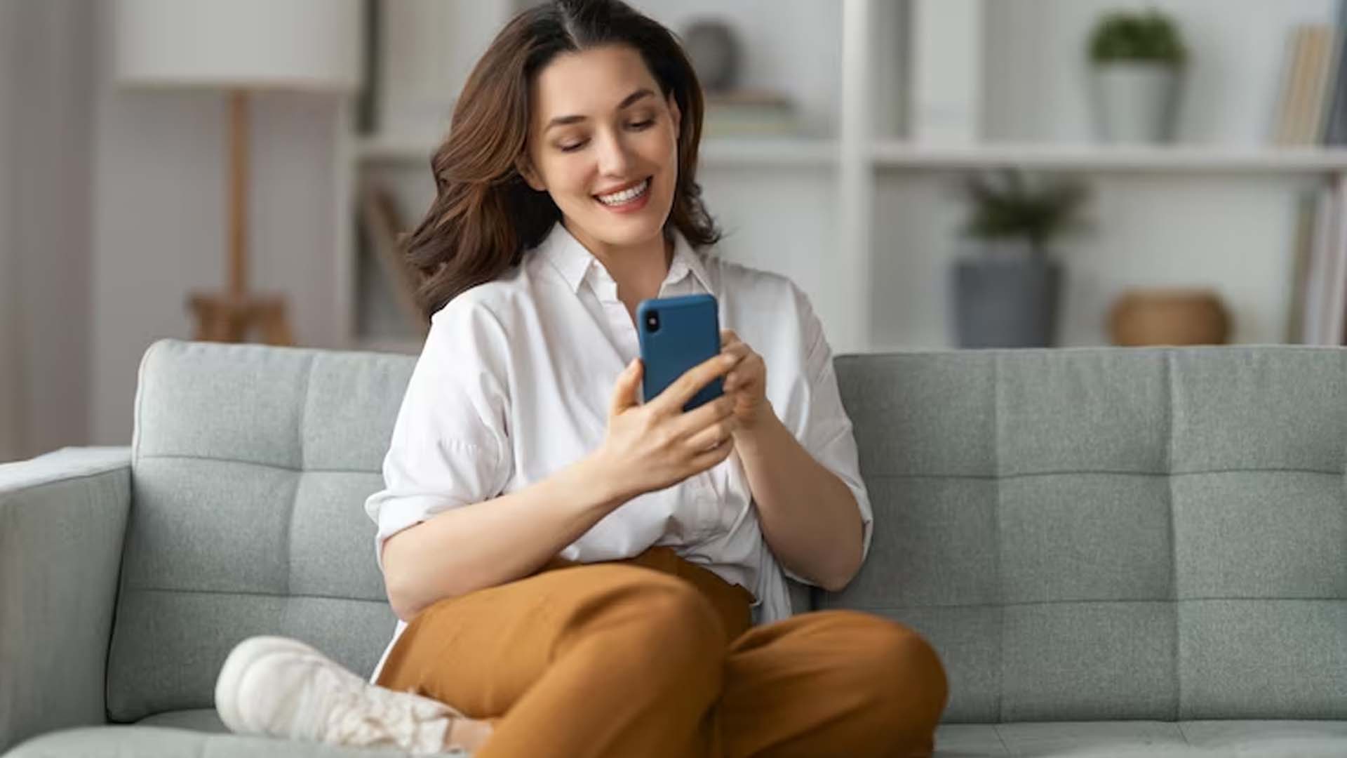 Women sitting on sofa Using Phone